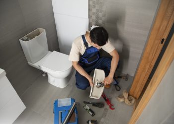 male-plumber-working-fix-problems-client-s-house