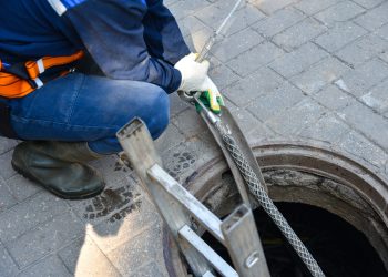 Workers dismantle the telecommunication cable in the well.